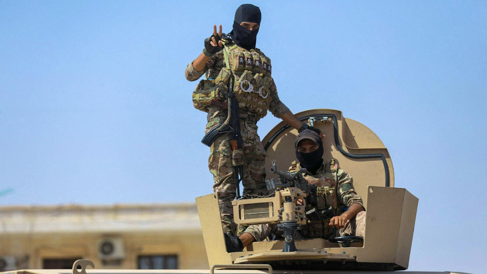 SDF fighters gesture while heading to the Dhiban frontline in Syria’s Deir Ezzor province, Sept. 4, 2023. (AFP)