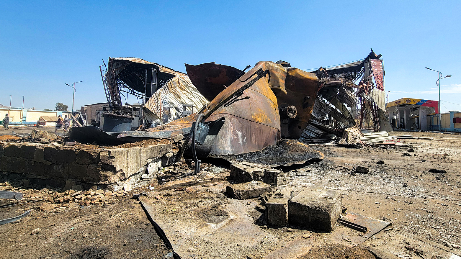 People inspect the damage at the site of an Israeli airstrike that targeted an oil company facility the previous day in Yemen's  Houthi-held capital Sanaa on Aug. 25, 2025. (AFP)