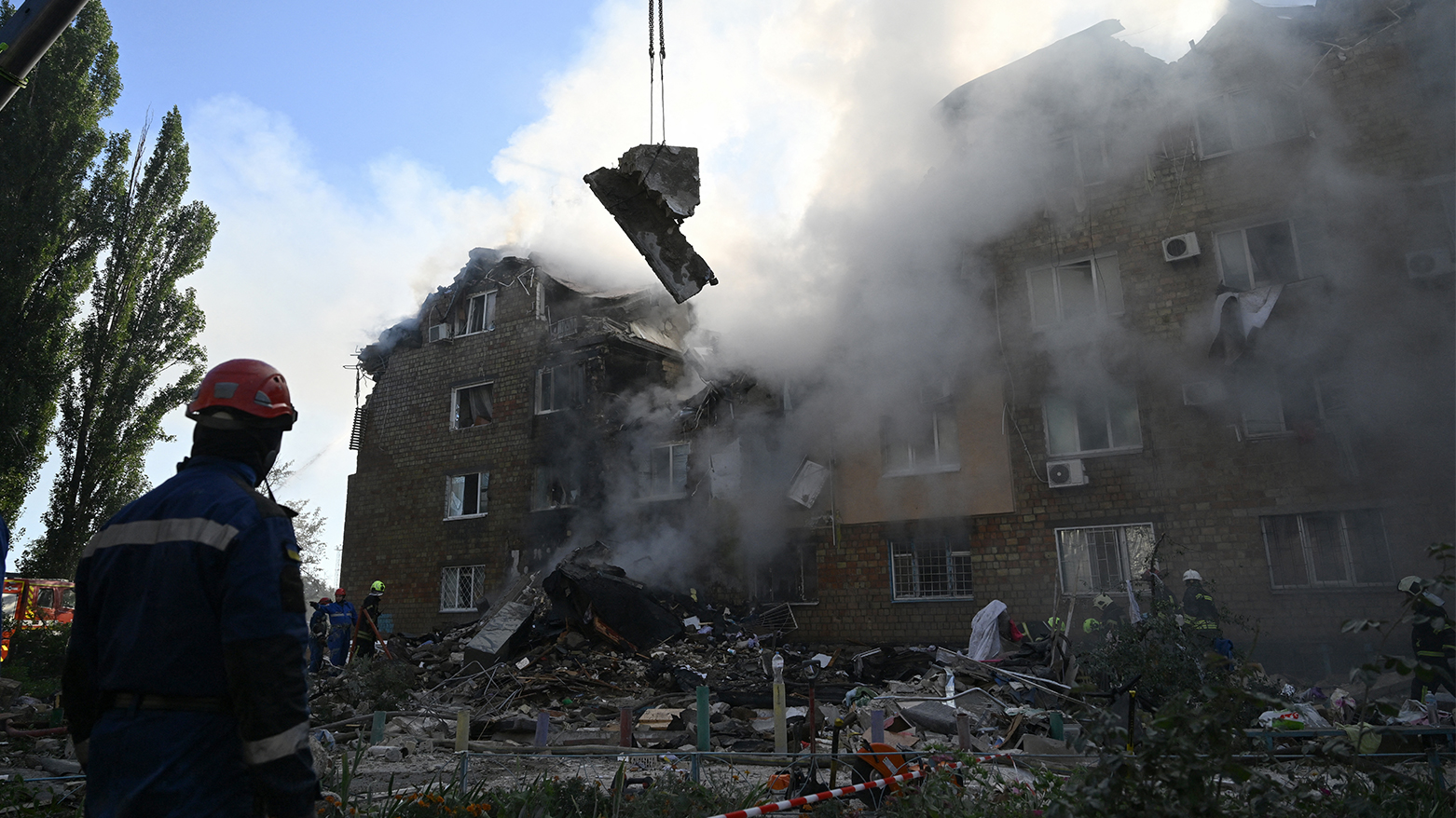 Ukrainian rescuers conduct a search and rescue operation in and around a residential building heavily damaged during a large-scale Russian drone and missile attack on Kyiv on Aug. 28, 2025, (AFP)