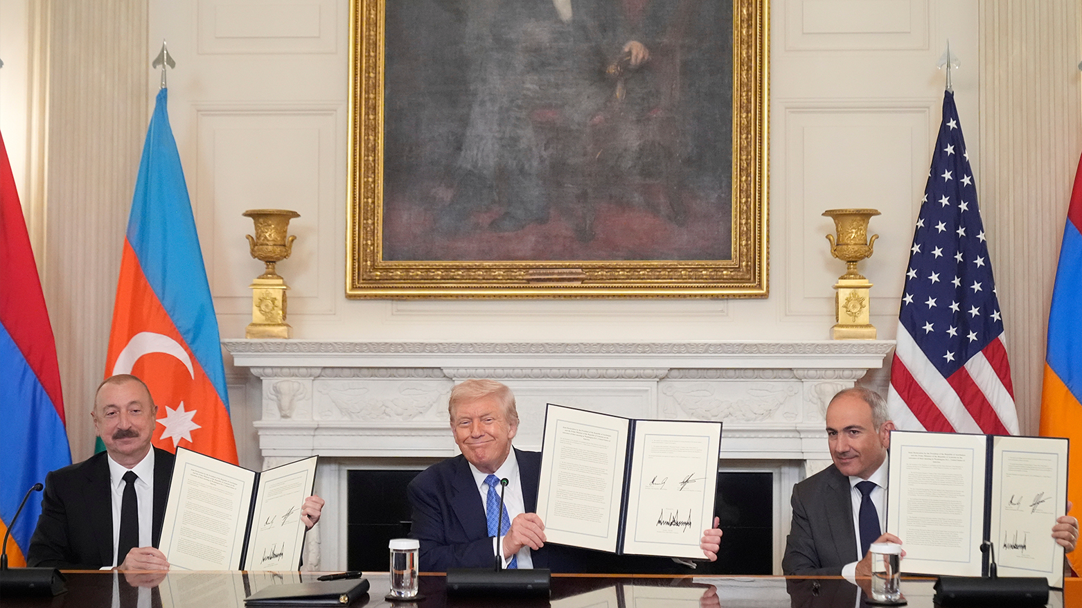Trump, Pashinyan, and Aliyev hold a signed pact at the White House, Aug. 8, 2025. (AP)