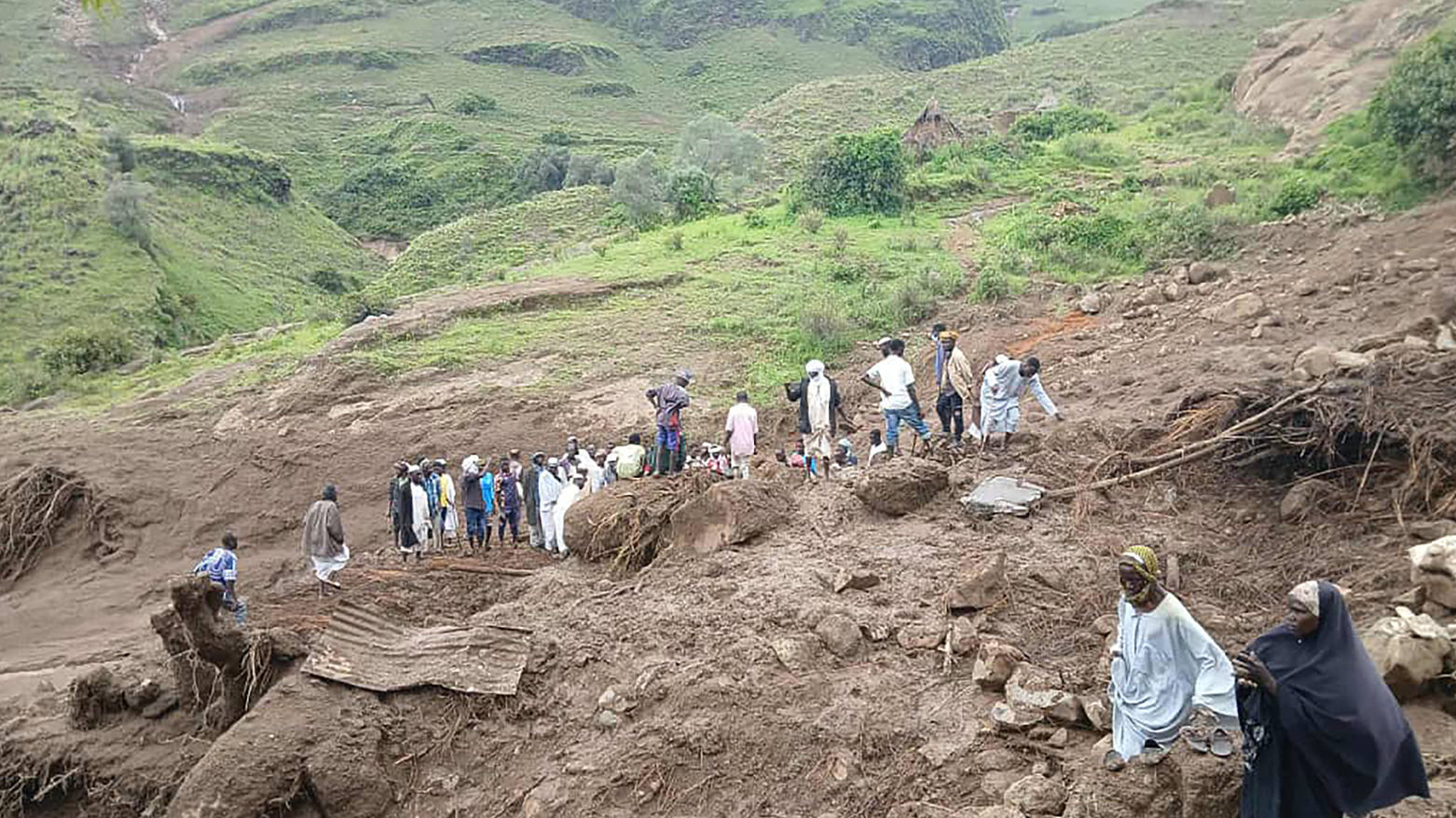 Photo shows people inspecting landslide debris in Tarasin, Sudan’s Jebel Marra, Sept. 2, 2025. (AFP)