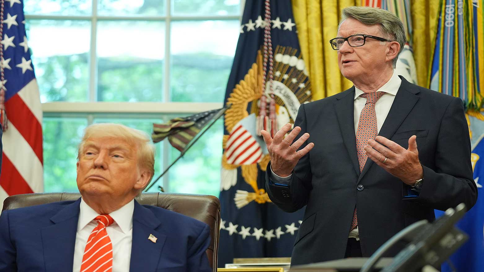 President Donald Trump, (L), listening to Britian's ambassador to US, Peter Mandelson, delivering remarks on a trade deal between U.S. and U.K. in the Oval Office of the White House, May 8, 2025. (Photo: AP)