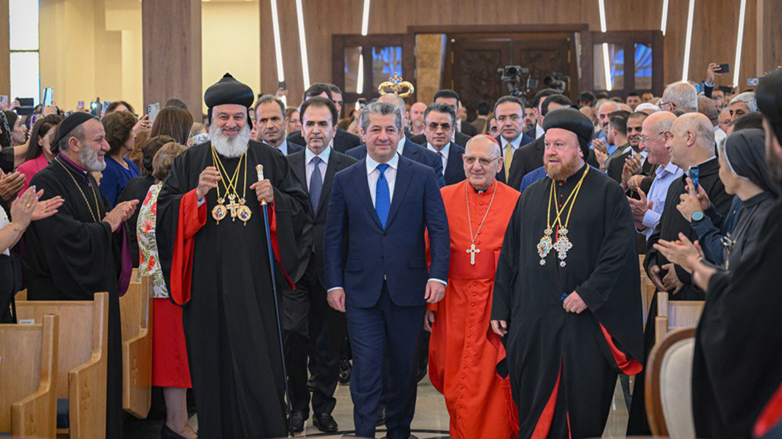 PM Masrour Barzani (C) with senior religious dignitaries at the inauguration of Umm al-Nour cathedral in Ankawa. (Photo: Kurdistan24)
