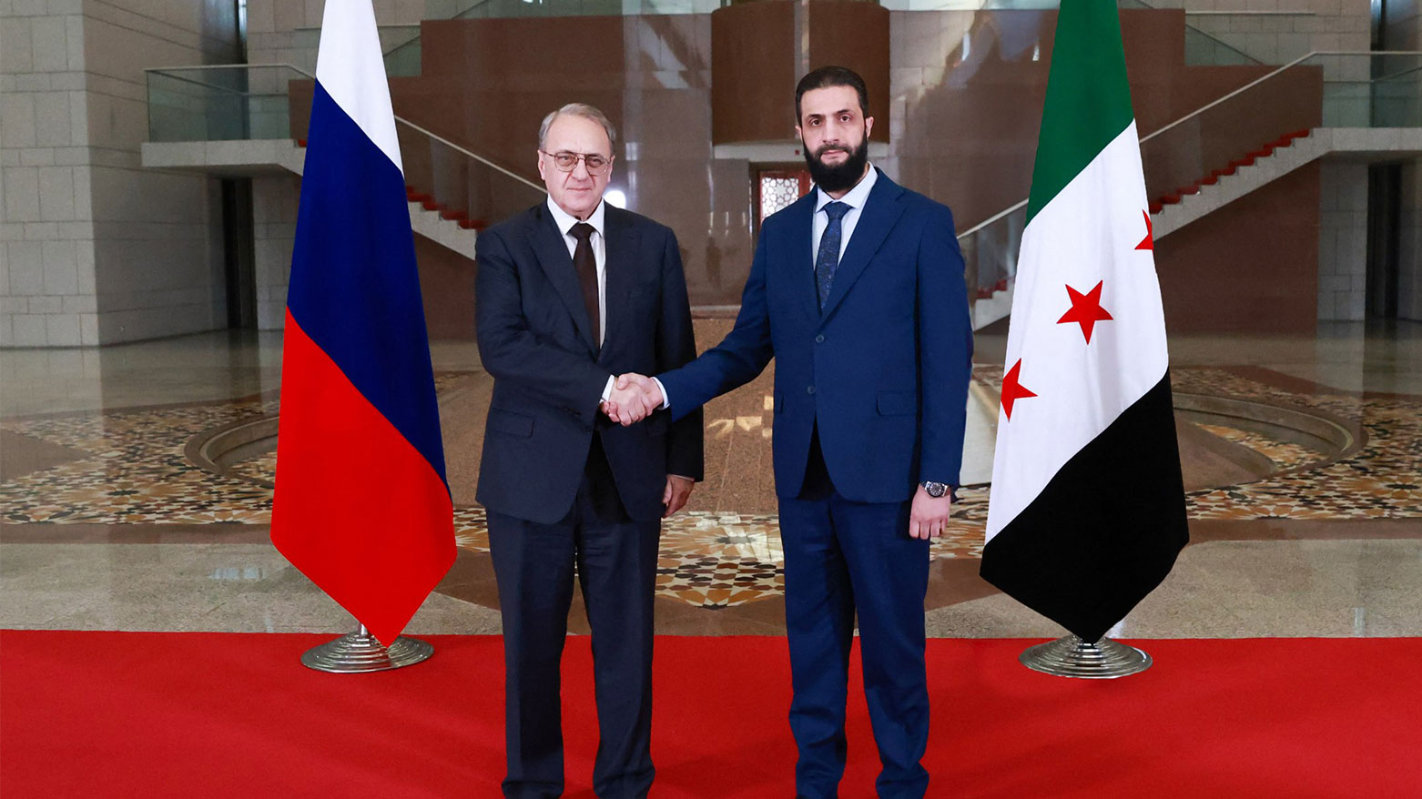 Syrian Interim President Ahmed al-Sharaa (R) and Russia's Deputy Foreign Minister Mikhail Bogdanov (L), in Damascus, on Jan. 29, 2025. (AFP)
