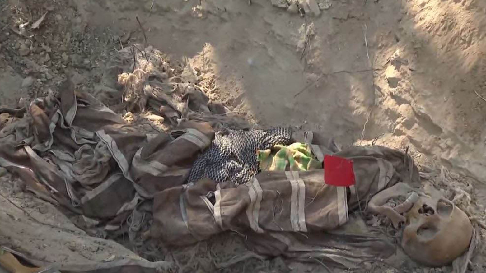 The remains of Anfal victims, still dressed in traditional Kurdish clothing, are uncovered from a mass grave in Mergati village, Amedi district, Duhok. (Photo: Kurdistan24)