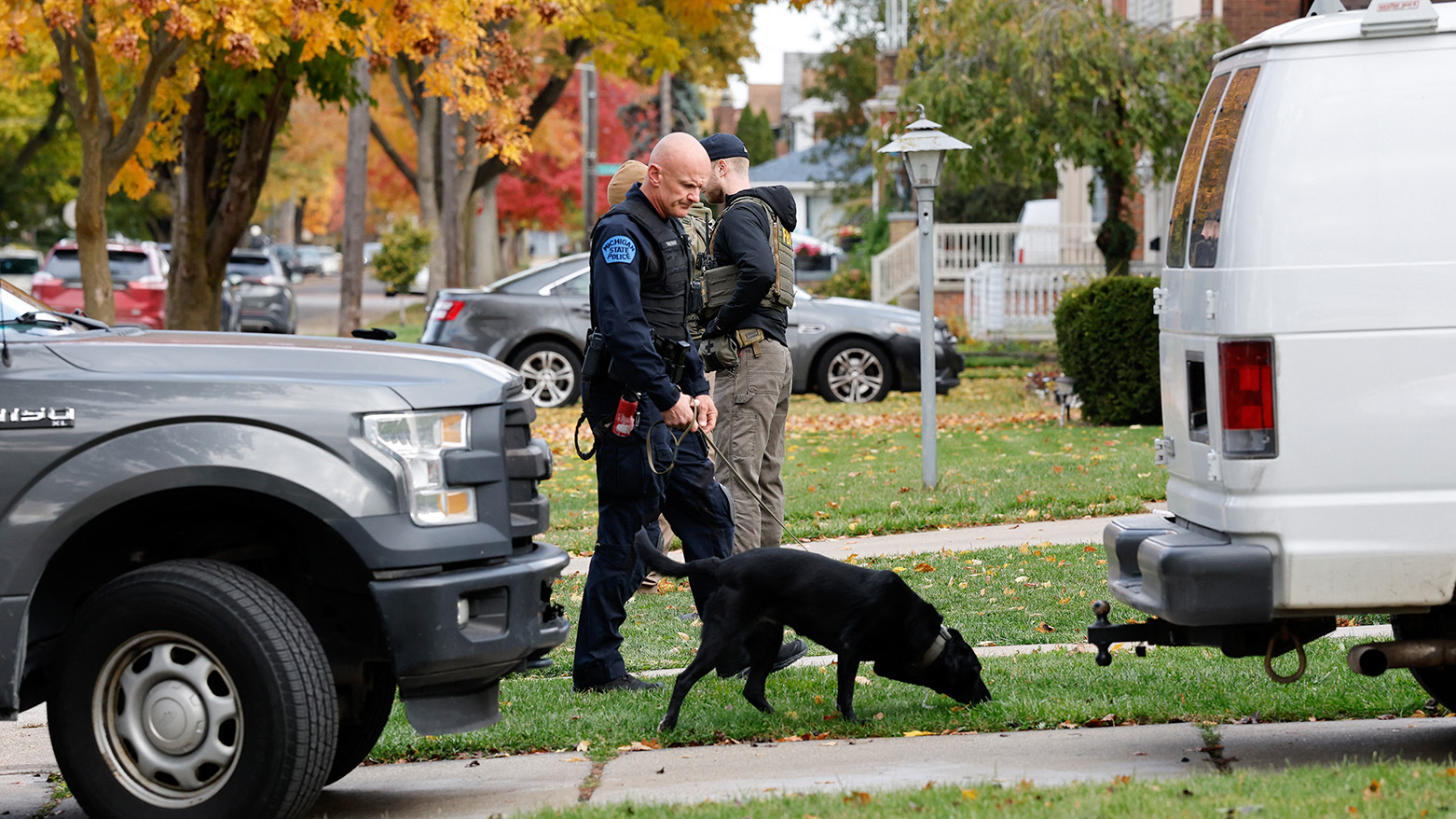 A Michigan State Police officer assists members of the FBI Joint Terrorism Task Force as they search a home in Dearborn, Michigan, on Oct. 31, 2025. (AFP)