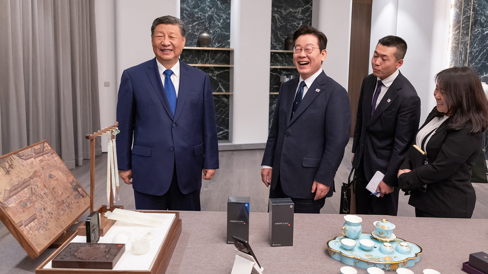 South Korea's President Lee Jae Myung (2nd L) and China's President Xi Jinping (L) exchanging gifts. (AFP)