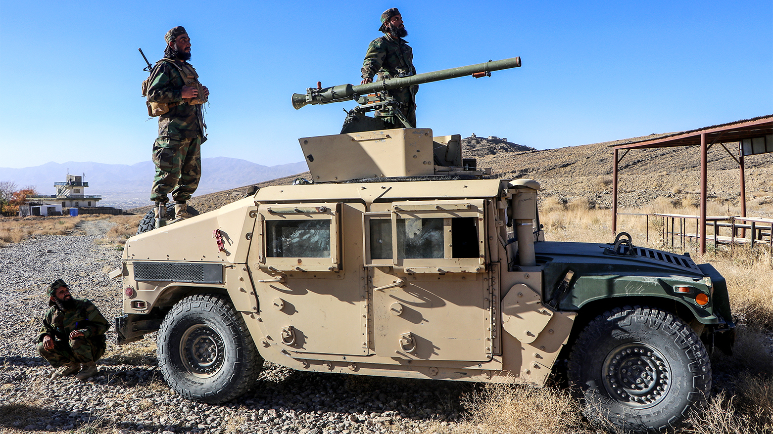 Newly recruited cadets of Afghan Taliban's Defense Ministry stand atop a military vehicle. (AFP)