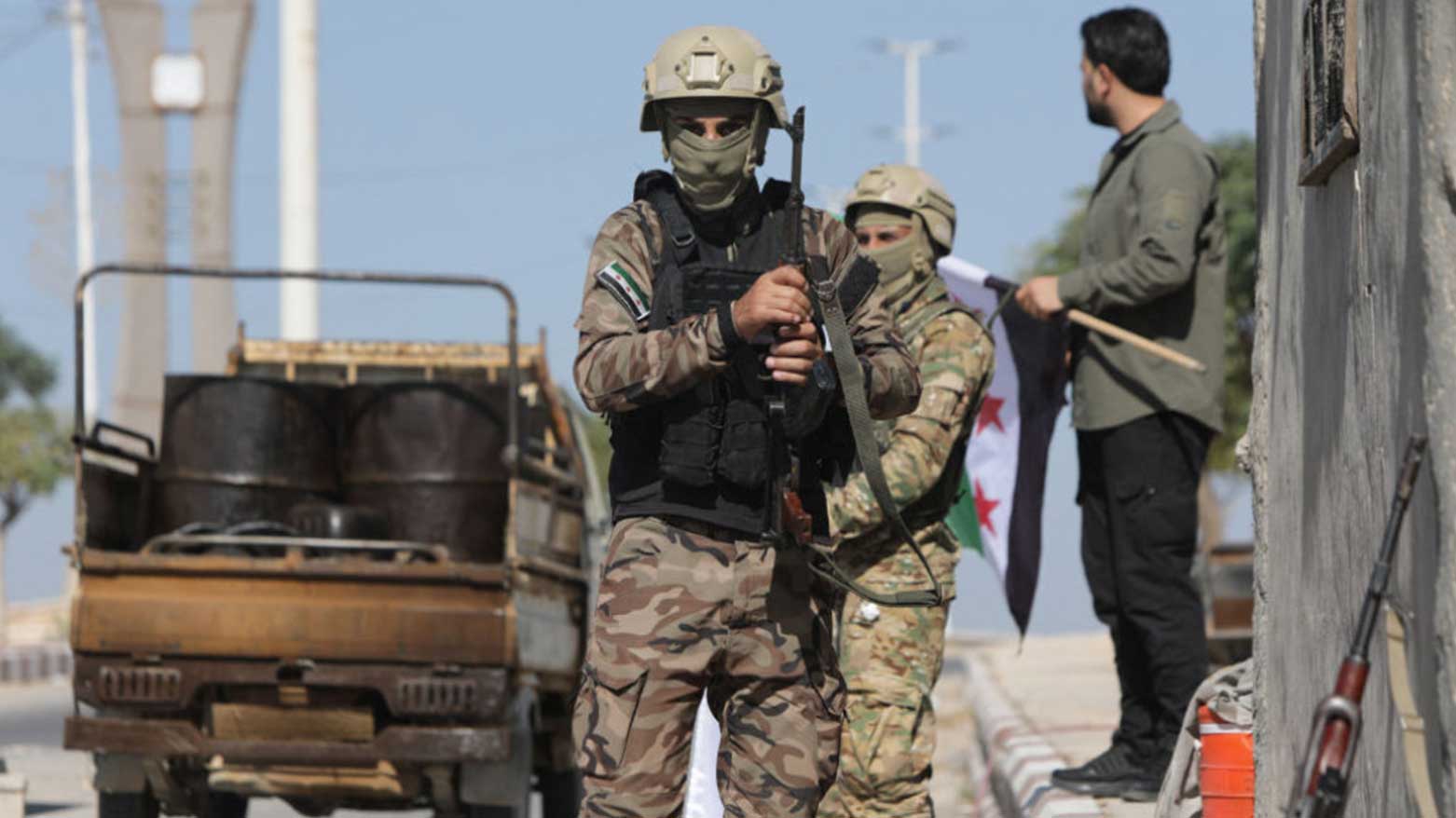 Syrian Army solders standing at a checkpoint. (Photo: AFP)