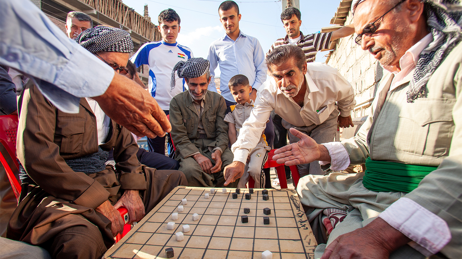 Kurdish men play dama, a game similar to checkers, in Erbil. (Photo: International Mission Board)