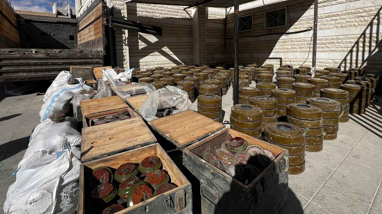 dozens of wooden crates and bag filled with landmines. (Photo: Syria’s Interior Ministry)