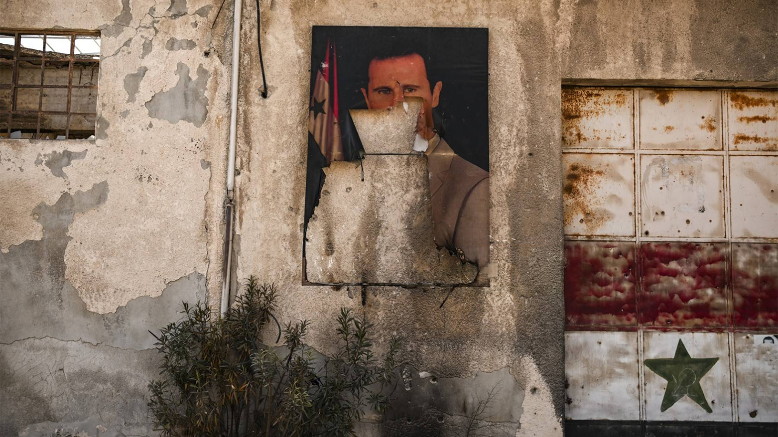 A vandalized portrait of the ousted Syrian President Bashar al-Assad on the outskirts of Damascus, Syria.(AFP)