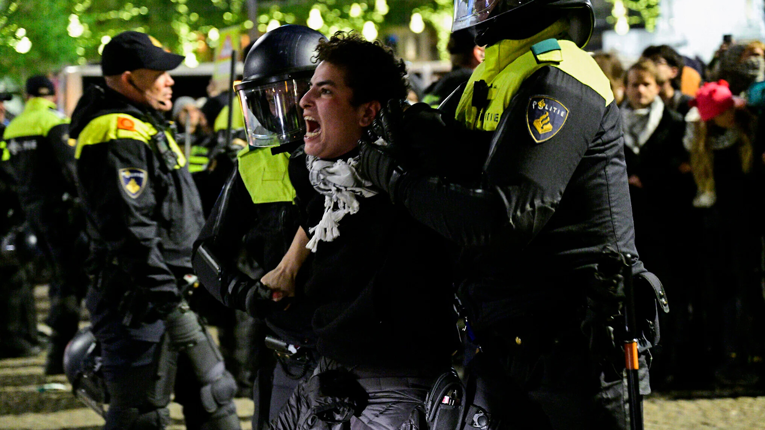 Police officers detain a protestor during an unauthorised pro-Palestinian demonstration in Amsterdam on Nov. 13, 2024. (AFP)