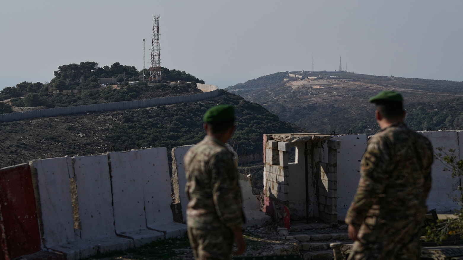 Lebanese army soldiers look at the Israeli military post of Hanita, left, and the Labbouneh post, one of five hills used by Israeli forces, in the village of Alma al-Shaab in south Lebanon,, Nov. 28, 2025. (AP)