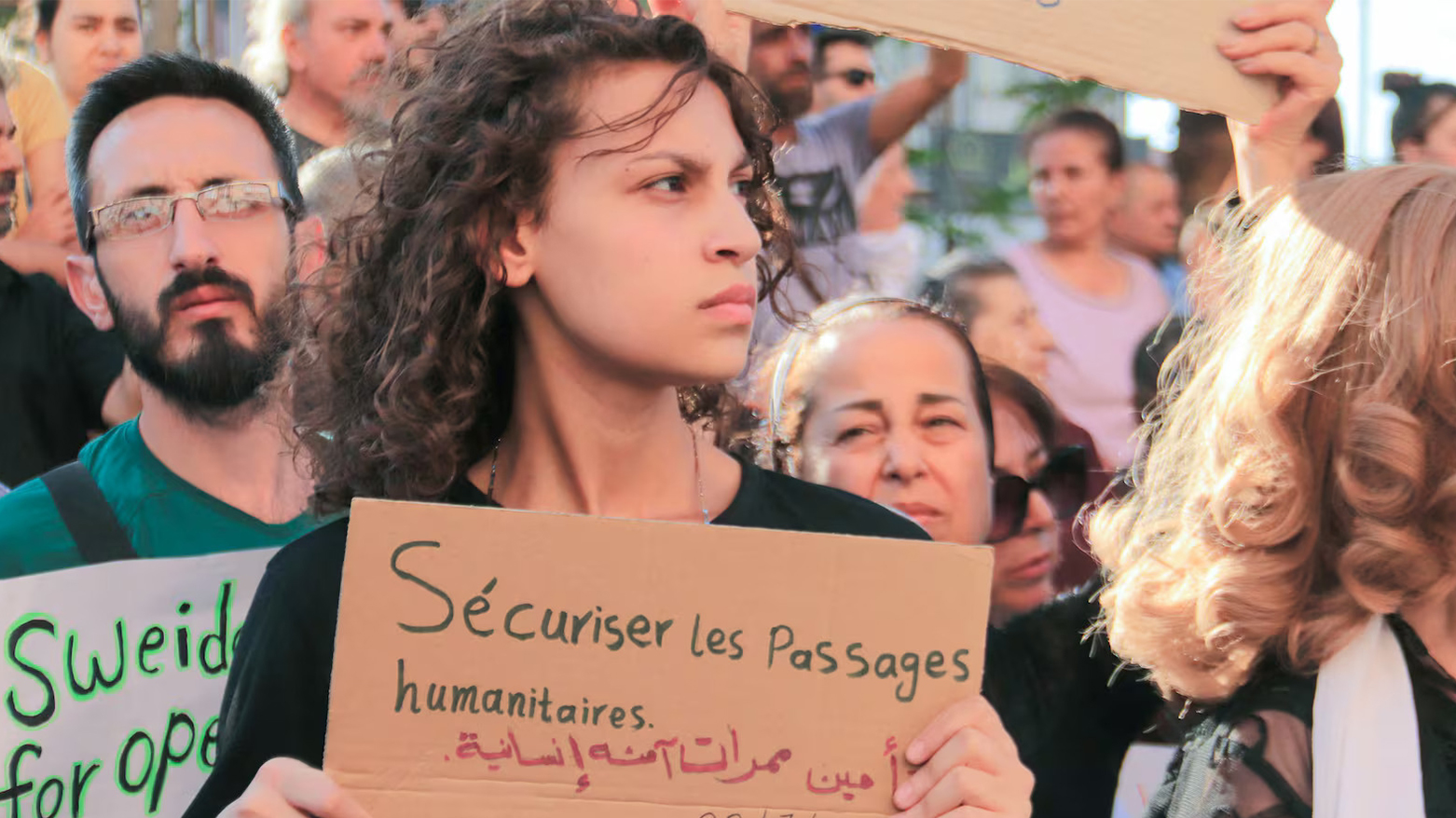 A Syrian carries a placard during protest of the humanitarian situation in the predominantly Druze city of Sweida on July 28, 2025. (AFP)