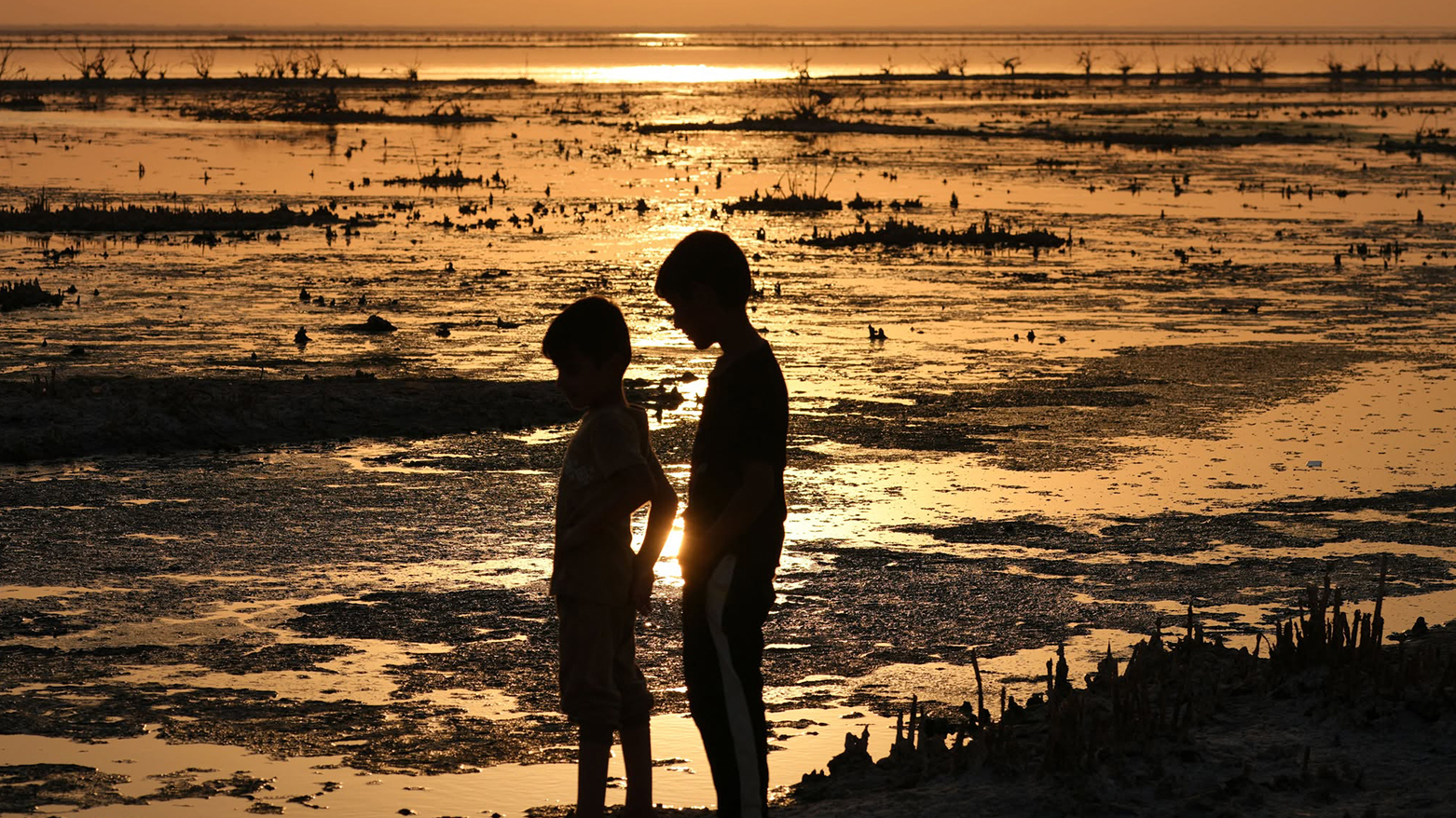 Boys play in Najaf's dried-up 'sea', once a lush Euphrates-fed lake, on Sept 9, 2025. (AFP)