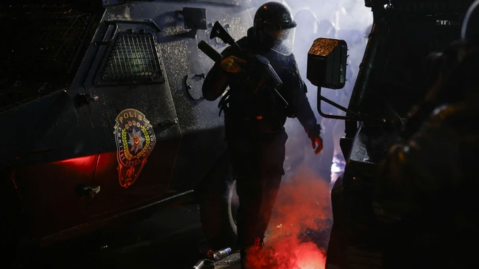 A Turkish police officer stands between armored vehicles in Istanbul on Mar. 23, 2025. (AFP)