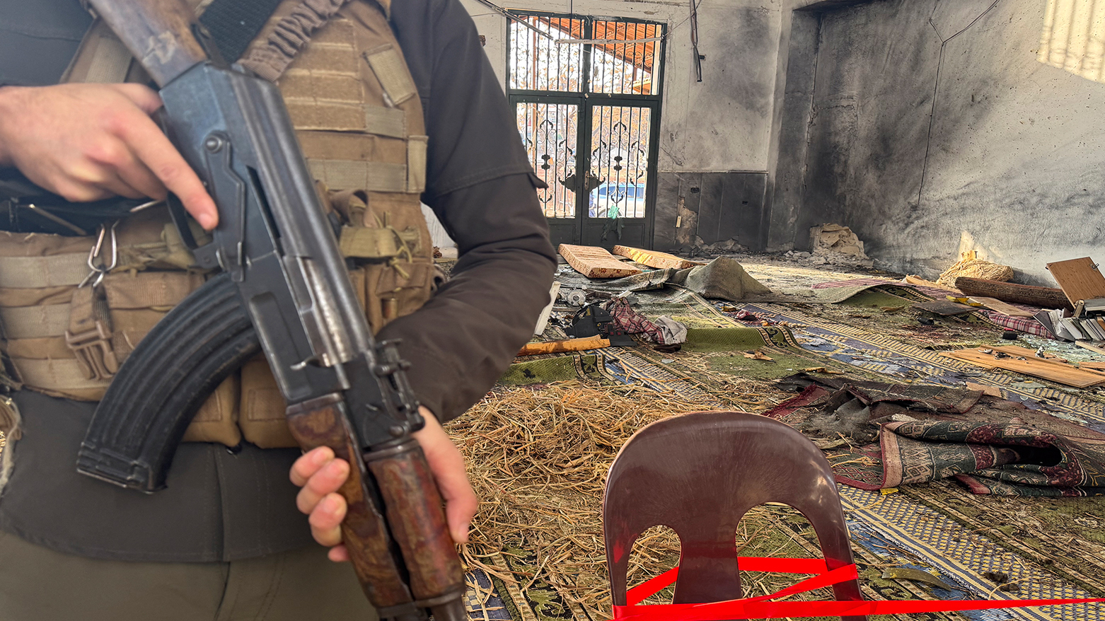 Security officers and members of the press gather outside Imam Ali ibn Abi Talib Mosque following an explosion in the Wadi al-Dahab neighborhood of Homs on December 26, 2025. (AFP)