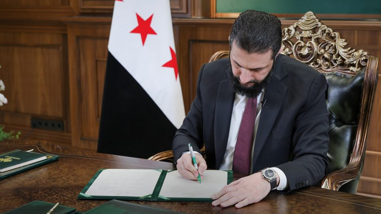 Syrian Interim President Ahmed al-Sharaa while signing the Decree No. 13 of 2026. (Photo: SANA)