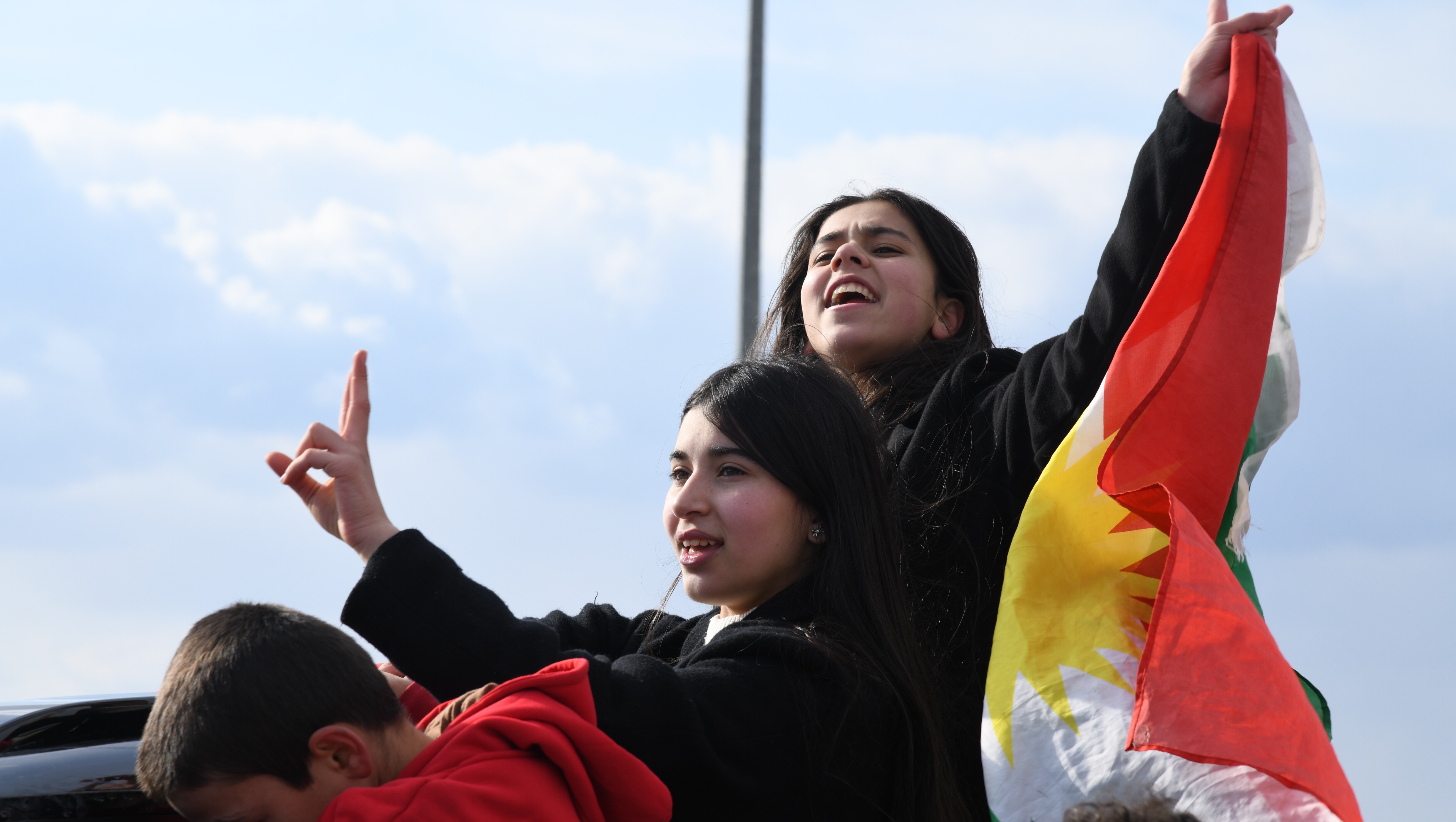 Young Kurdish girls hold the Kurdistan flag and chant during a rally in Erbil, Jan. 20, 2026. (Photo: Kurdistan24)