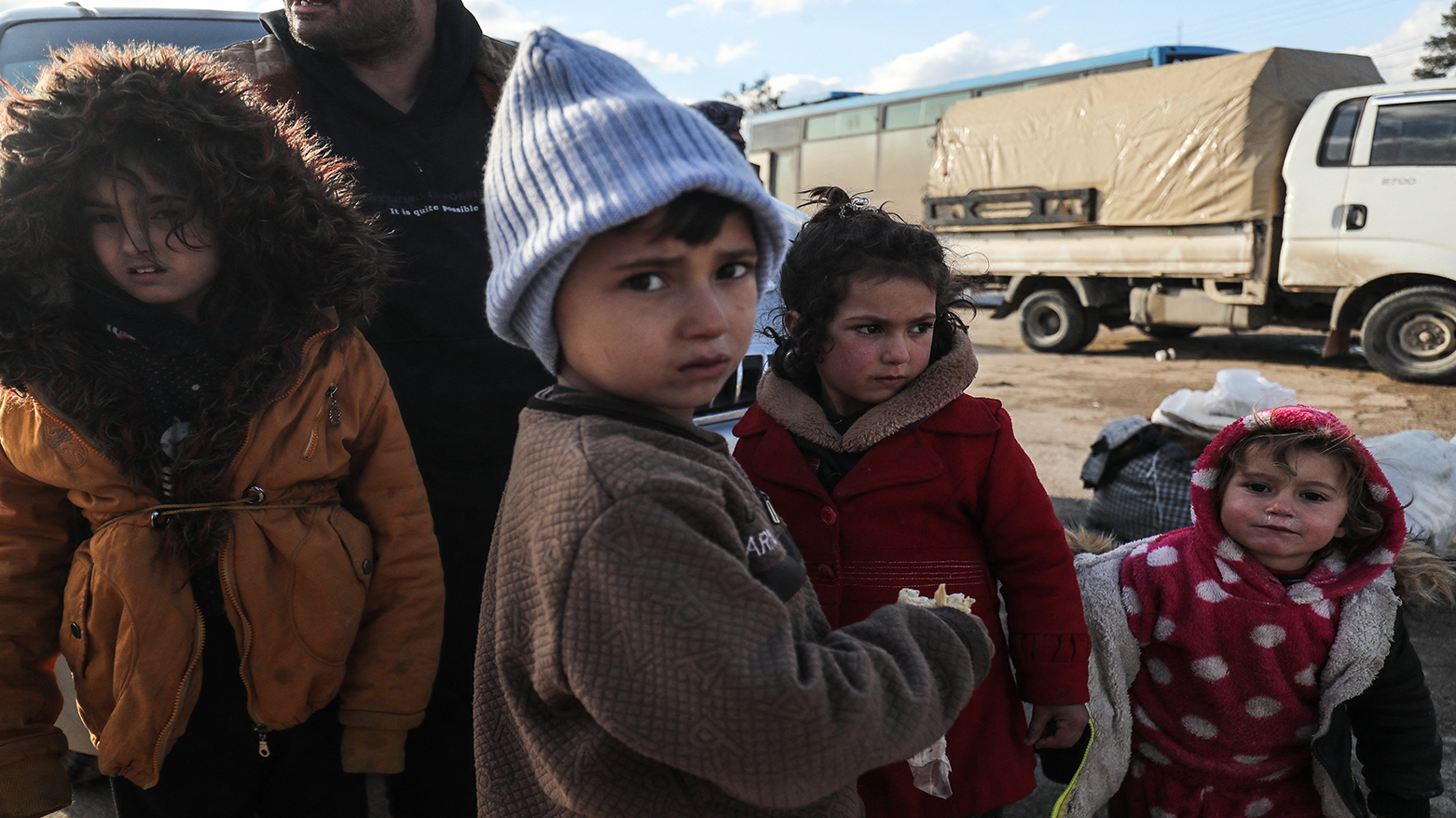 Kurdish children and their families fleeing a government advance through Kurdish-controlled areas arrive in the Kurdish Syrian city of Qamishli on January 19, 2026. (AFP)