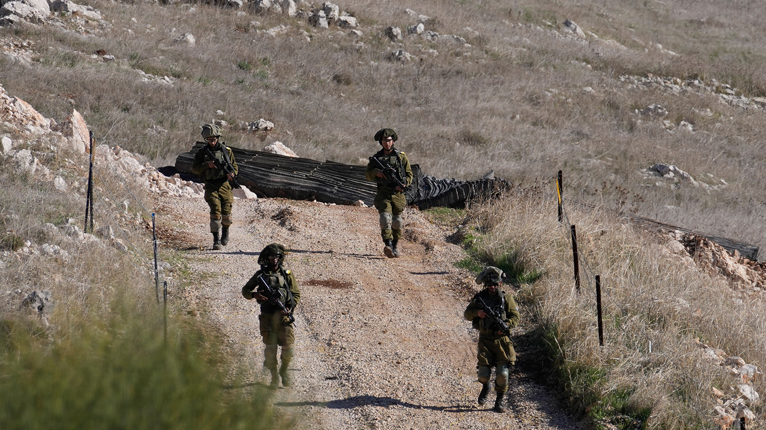 Israeli soldiers walking down a hill in the Israeli-controlled Golan Heights. (AP)