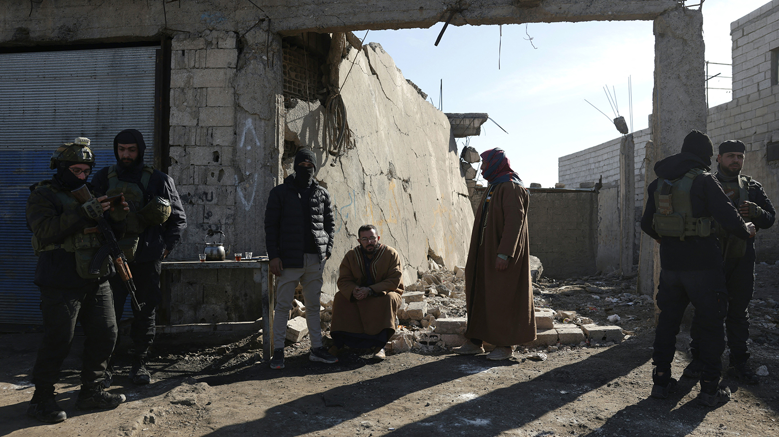 Family members of detainees in Al-Aqtan prison on the outskirts of the city of Raqqa wait outside the facility, Jan. 21, 2026. (AFP)