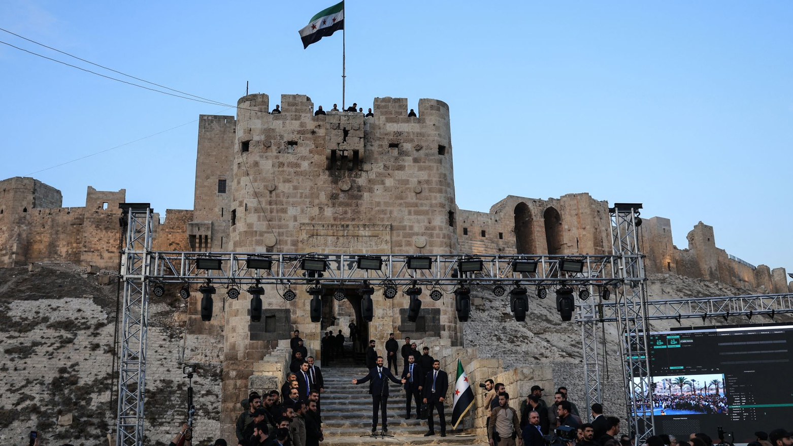 Syrian President Ahmed al-Sharaa waves to the crowd at the gate of Aleppo’s Citadel, on Nov. 29, 2025. (AFP)