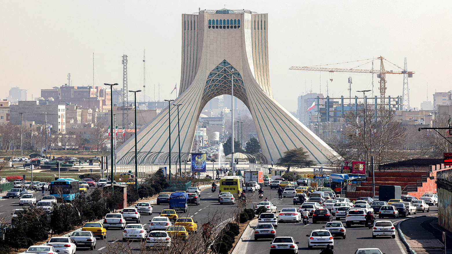 Vehicles move along a highway near Tehran's landmark Azadi (Freedom) Tower, Feb. 23, 2026. (AFP)