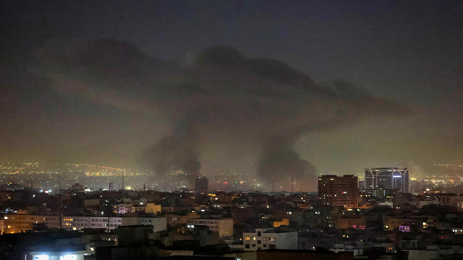 Plumes of smoke rise following reported explosions in Tehran early on March 3, 2026. (AFP)