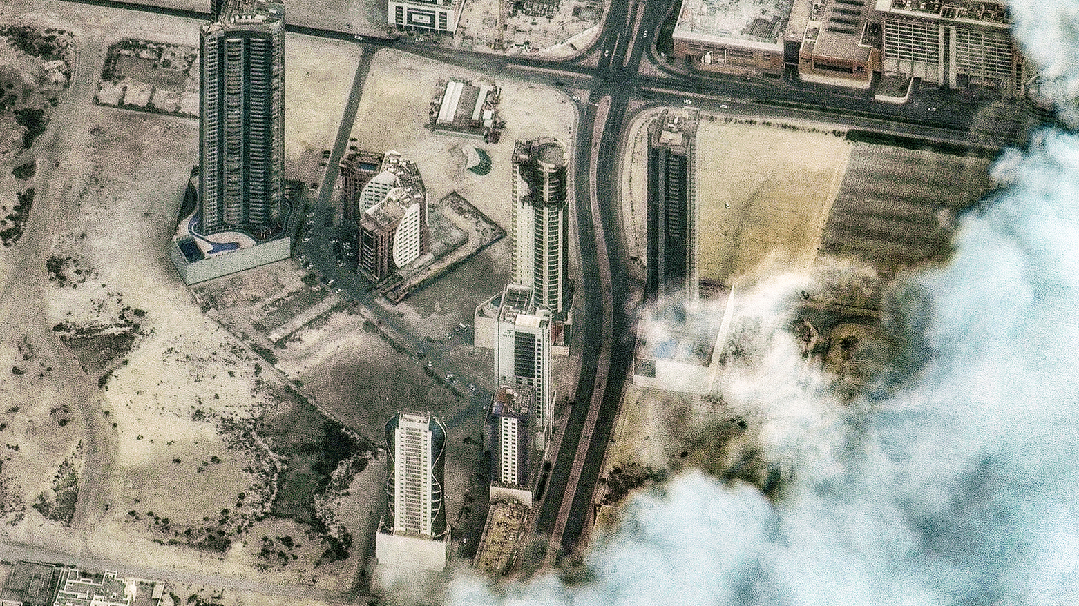 This satellite image shows damage following a drone attack on a high-rise apartment building in Bahrain's capital Manama on March 2, 2026. (AFP)