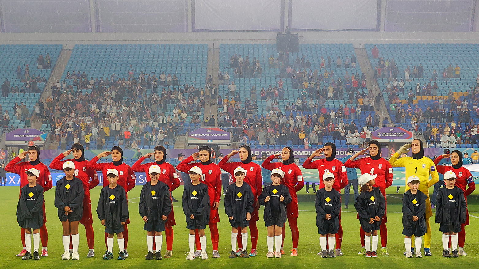 Iranian players salute during the national anthem before the AFC Women's Asian Cup Australia 2026 football match between Iran and Philippines in Gold Coast on March 8, 2026. (AFP)