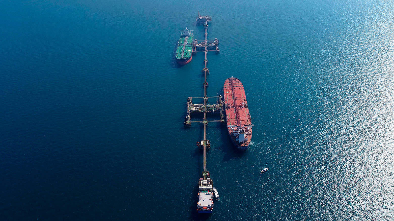 An aerial photo shows oil tankers load crude oil at Iraq's Al-Basra Offshore Terminal in Basra, Iraq, Sunday, Dec. 27, 2020. (AP)