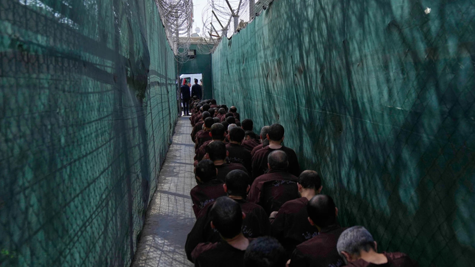 Iraqi security forces lead suspected Islamic State militants for questioning, after they were transferred from Syria to Iraq, at Al-Karkh Central Prison in Baghdad, Iraq, Thursday, Feb. 12, 2026. (AP)