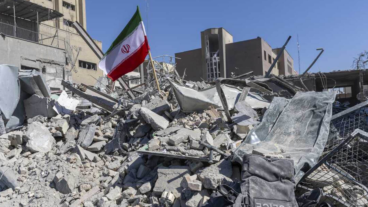 An Iranian flag is placed among the ruins of a police station struck Monday during the U.S.–Israeli military campaign in Tehran, Iran, Tuesday, Mar. 3, 2026. (AP)