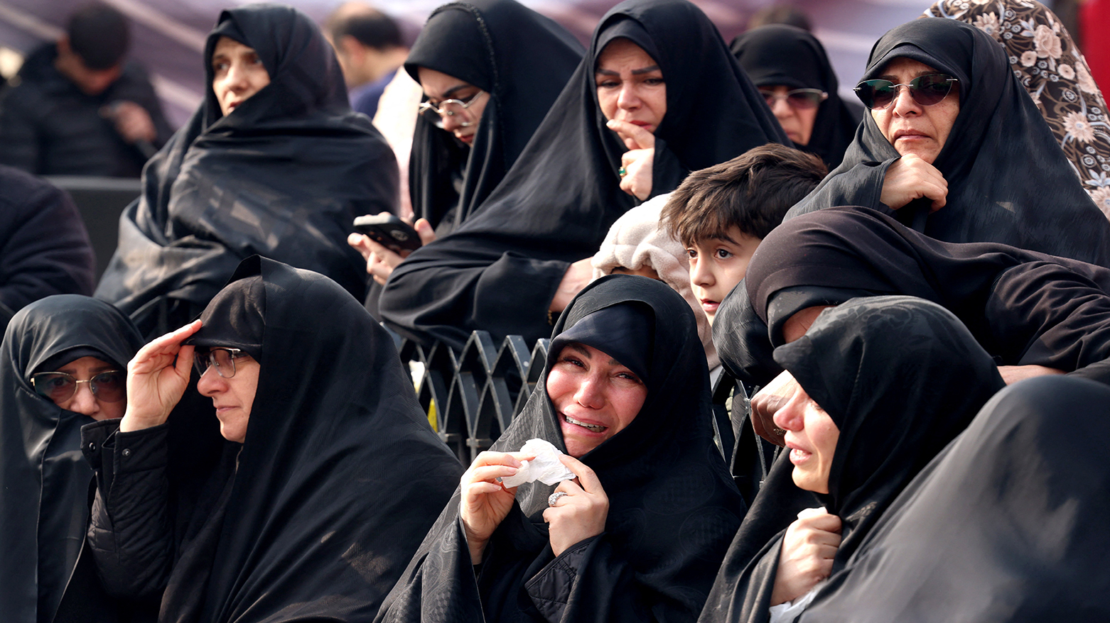 Family members and relatives of Ali Shamkhani, Iran's slain influential security adviser, react during his funeral at the Imamzadeh Saleh shrine in Tajrish square in Tehran, March 14, 2026. (AFP)