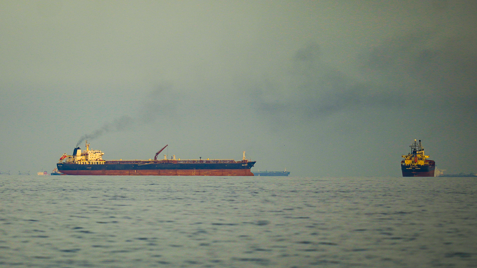 Oil tankers and cargo ships line up in the Strait of Hormuz as seen from Khor Fakkan, United Arab Emirates, March 11, 2026. (AP)