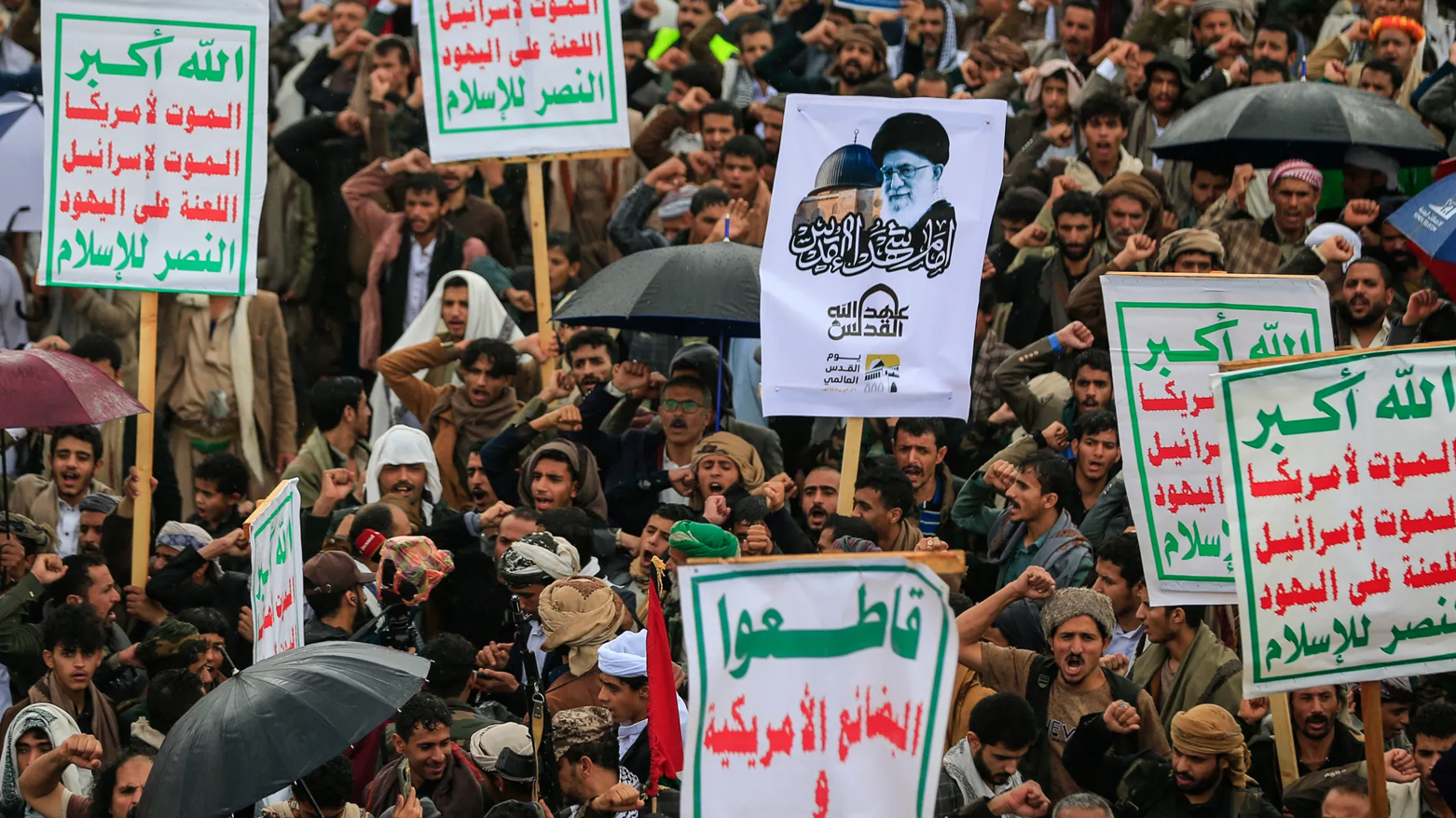 Supporters of Yemen's Houthi rebels hold a placard bearing a portrait of Iran’s slain supreme leader Ayatollah Ali Khamenei, Sanaa, March 13, 2026. (AFP)