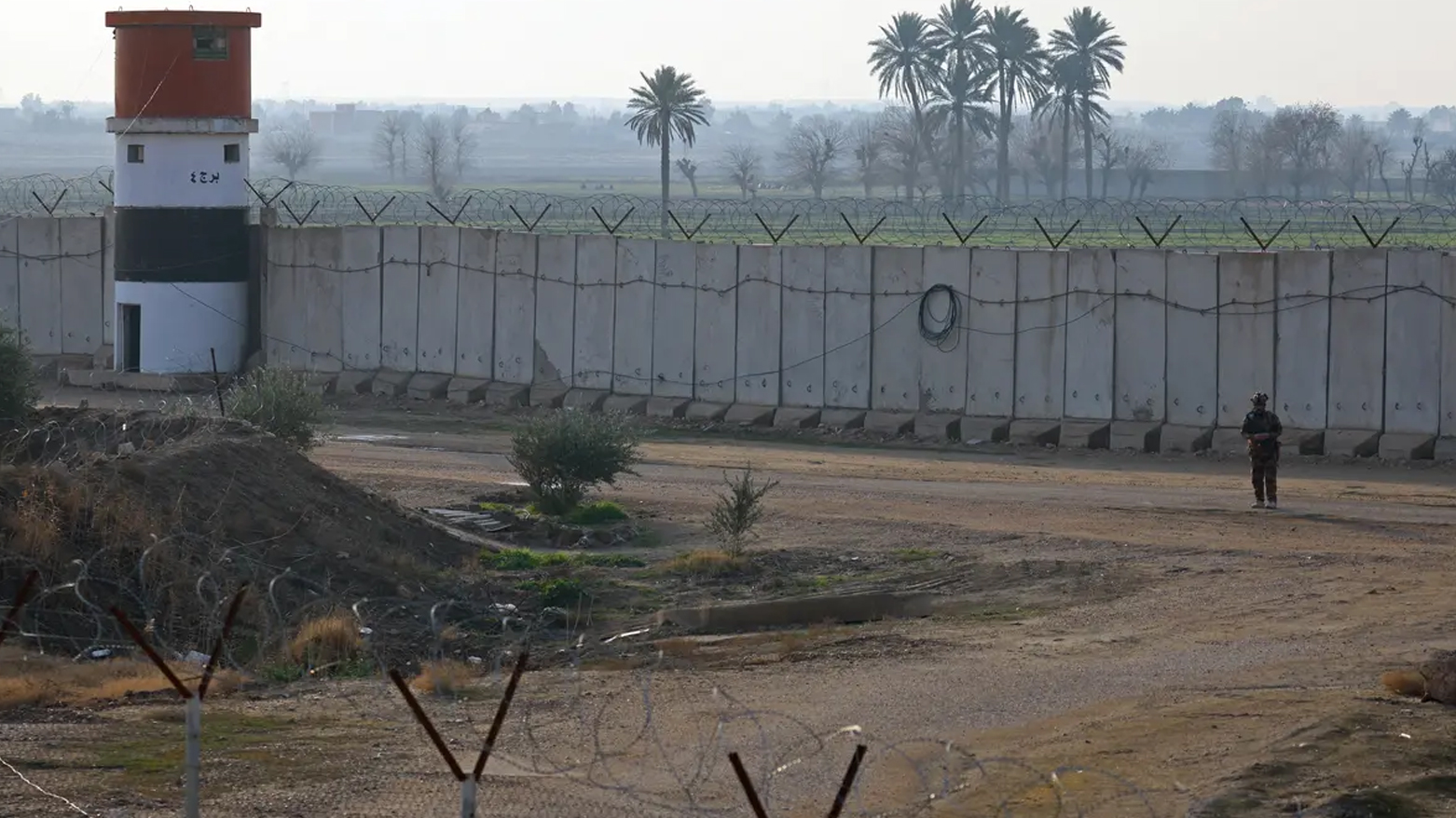 A member of the PMF patrols along a concrete wall at the Iraqi-Syrian border in Al-Qaim, west of Iraq on Jan. 23, 2026. (AFP)