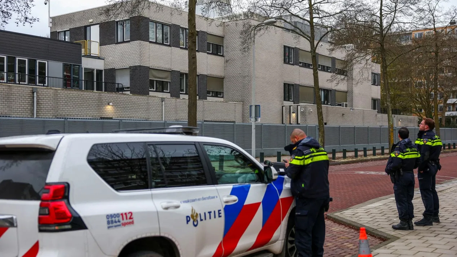 Police officers stand outside a Jewish school following an explosion that caused minor damages, in Amsterdam, Netherlands, March 14, 2026. (photo credit: Reuters)