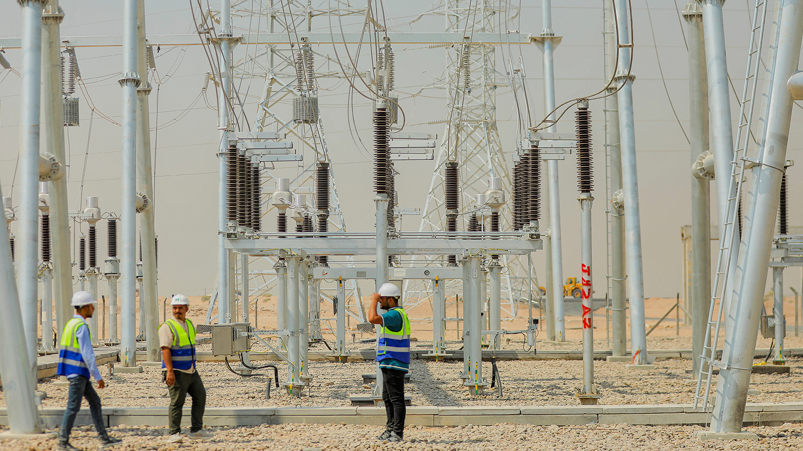 Workers stand at a newly opened power plant in Karbala, Iraq, Sept. 17, 2025. (AP)