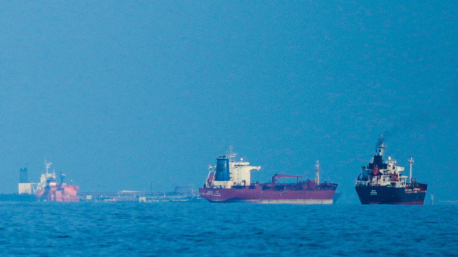 Oil tankers and cargo ships line up in the Strait of Hormuz as seen from Khor Fakkan, United Arab Emirates, Wednesday, March 11, 2026. (AP Photo