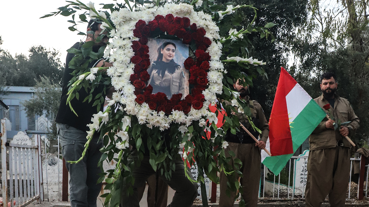 Members of the Kurdish opposition Komala party of Eastern Kurdistan attend the burial ceremony of slain Peshmerga Ghazal Mawlan at Sulaimani funeral, April 16, 2026. (AFP)