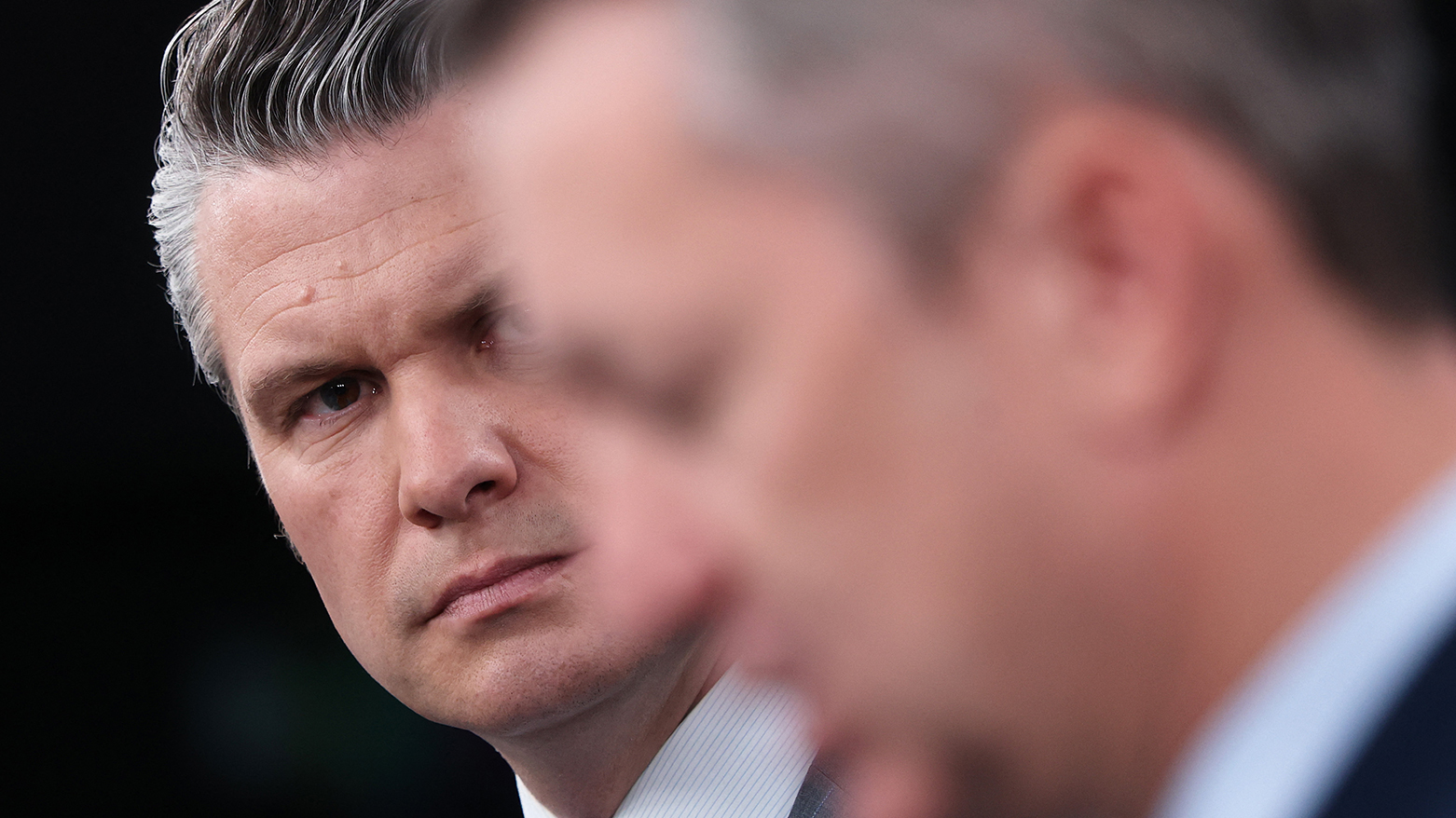 U.S. Secretary of War Pete Hegseth (L) looks on as Chairman of the Joint Chiefs of Staff Gen. Dan Caine. (AFP)