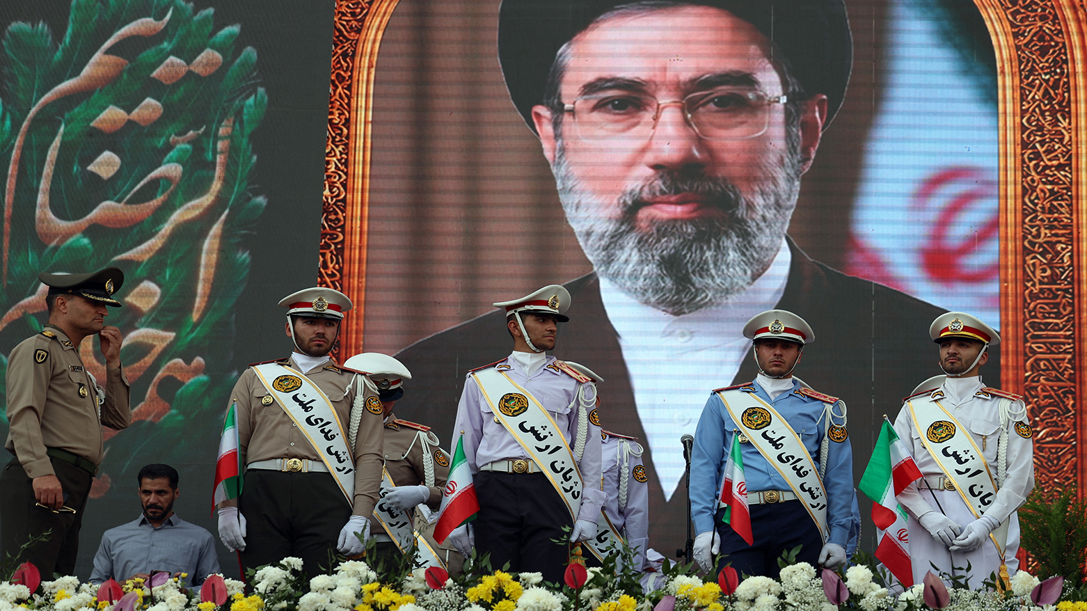 Iranian soldiers stand before a portrait of Mojtaba Khamenei during a rally in Tehran, April 29, 2026. (AFP)