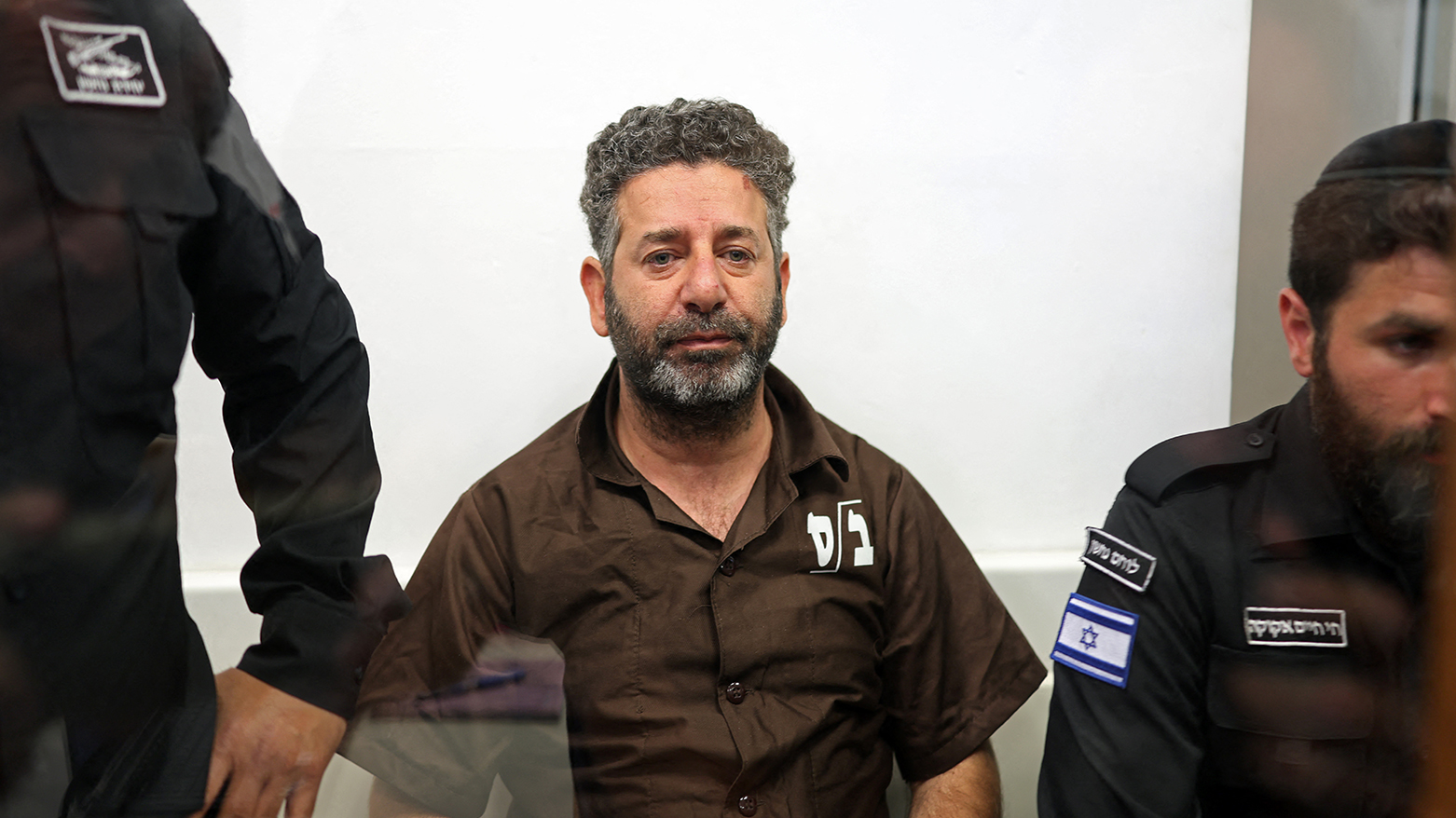 Security personnel escort Brazilian activist Thiago Avila to a court in Ashkelon on May 3, 2026. (AFP)