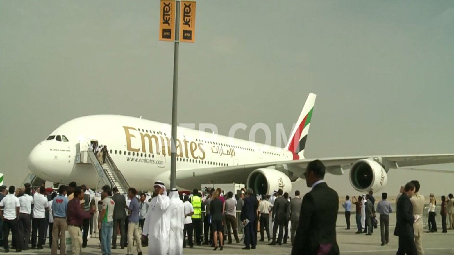 Passengers prepare to board a state-owned Emirates Group aircraft at Dubai International Airport. (Photo: AFP)