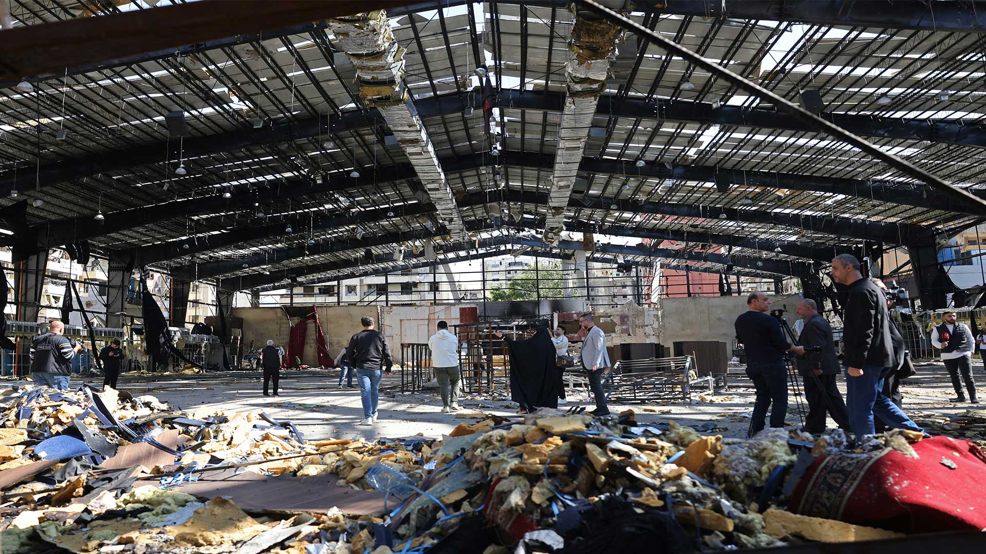 Journalists gathered at the destroyed Sayyid al-Shuhada complex in Beirut's southern suburbs on May 6, 2026. (Photo: AFP)