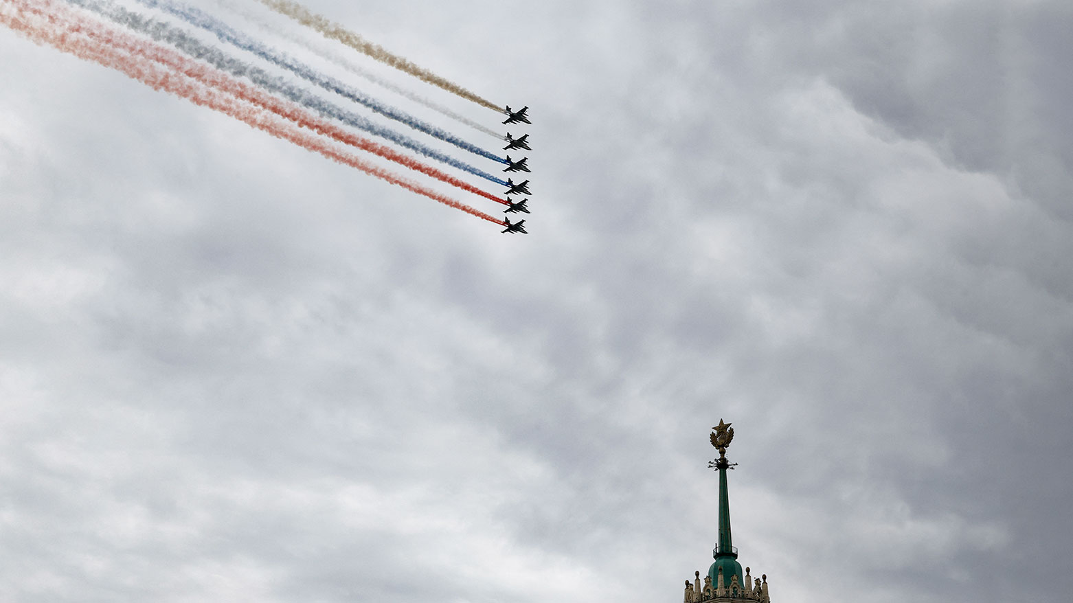 Russian Sukhoi SU-25 fighter jets release smoke in the colours of the Russian tricolor flag as they fly over central Moscow during the Victory Day military parade on May 9, 2026. (AFP)