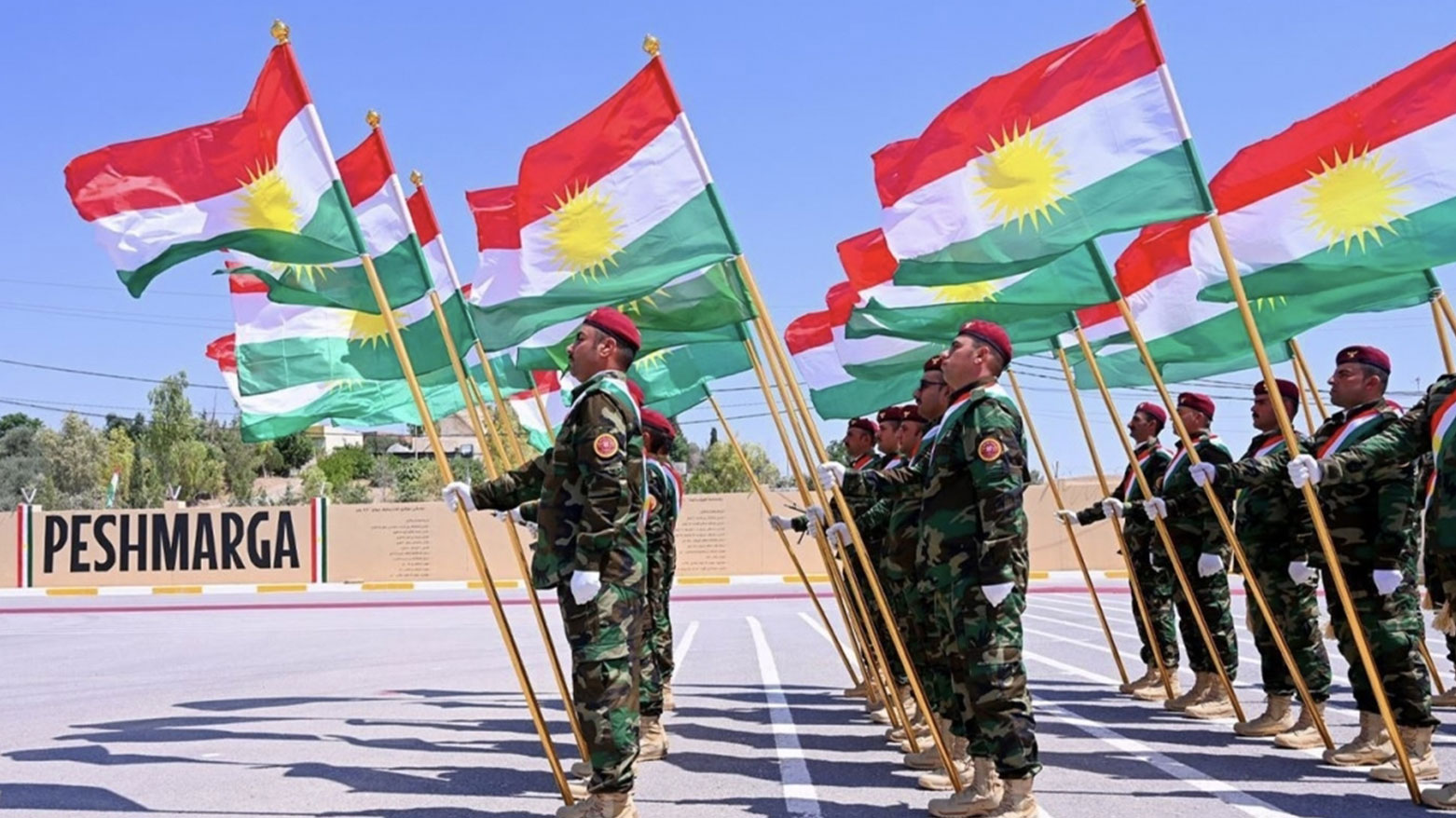 Kurdistan's Peshmerga officers holding flags of Kurdistan. (Photo: Archive)